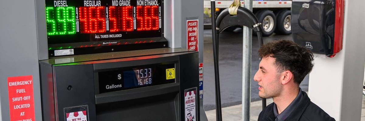 A man watches his gas pump price rise.