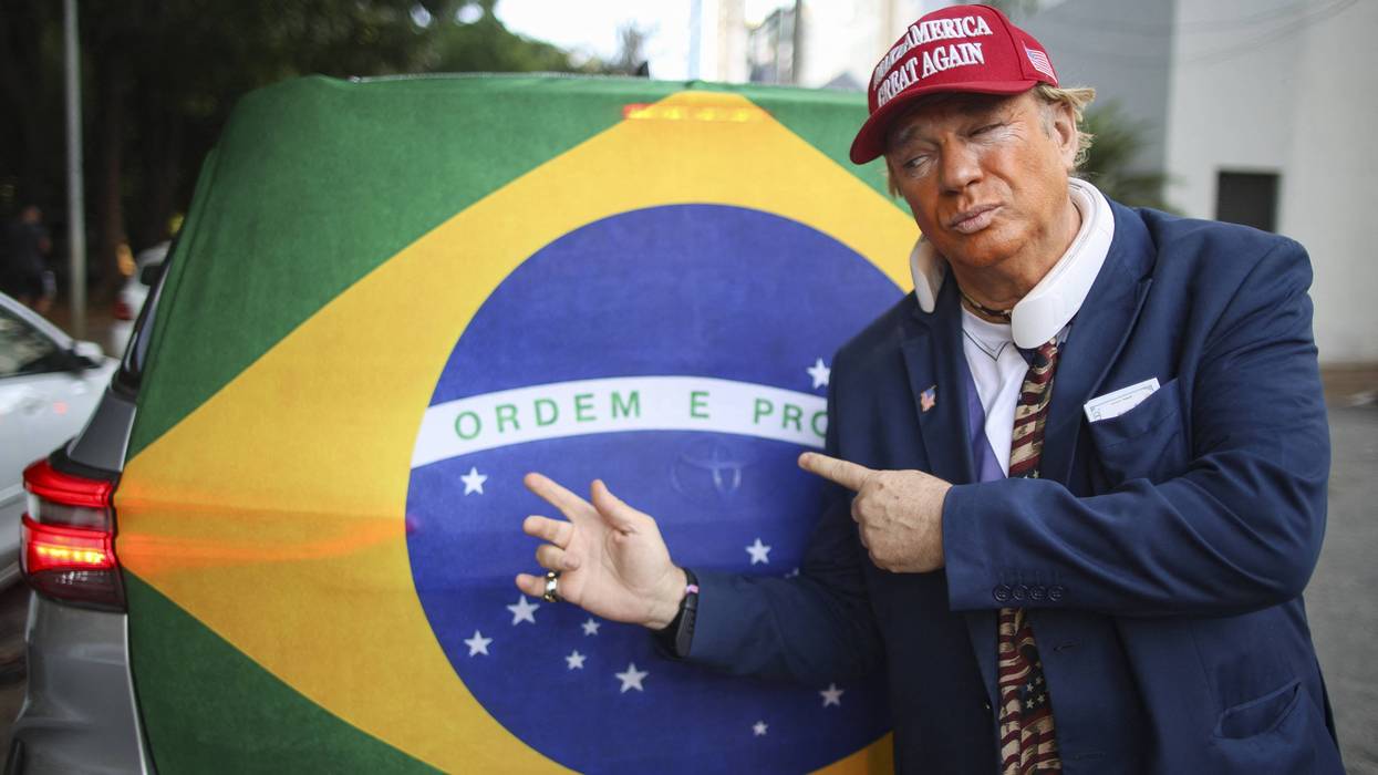 A man wearing a mask depicting US President Donald Trump