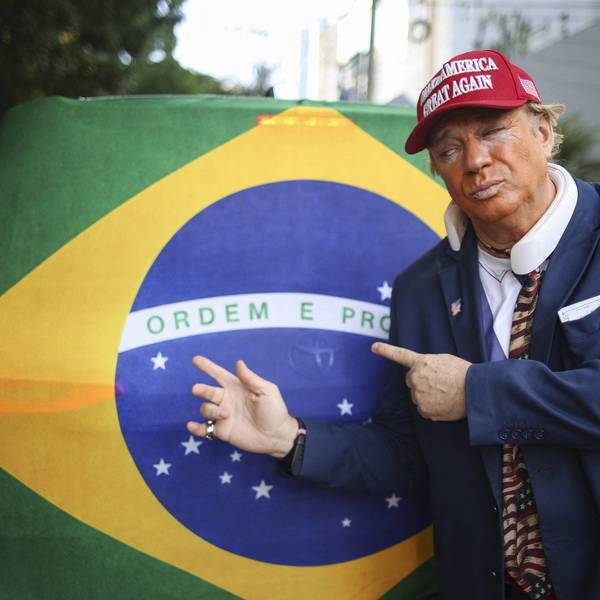A man wearing a mask depicting US President Donald Trump