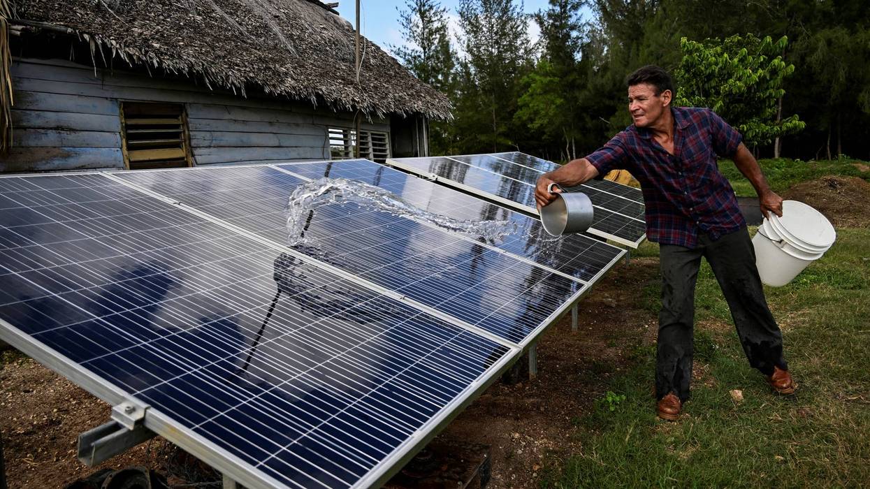 A man with solar panels in Cuba.