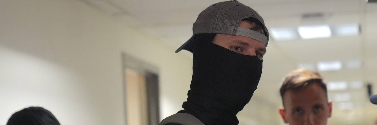 A masked federal immigration agent.