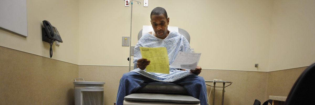 A Medicaid patient looks at paperwork.