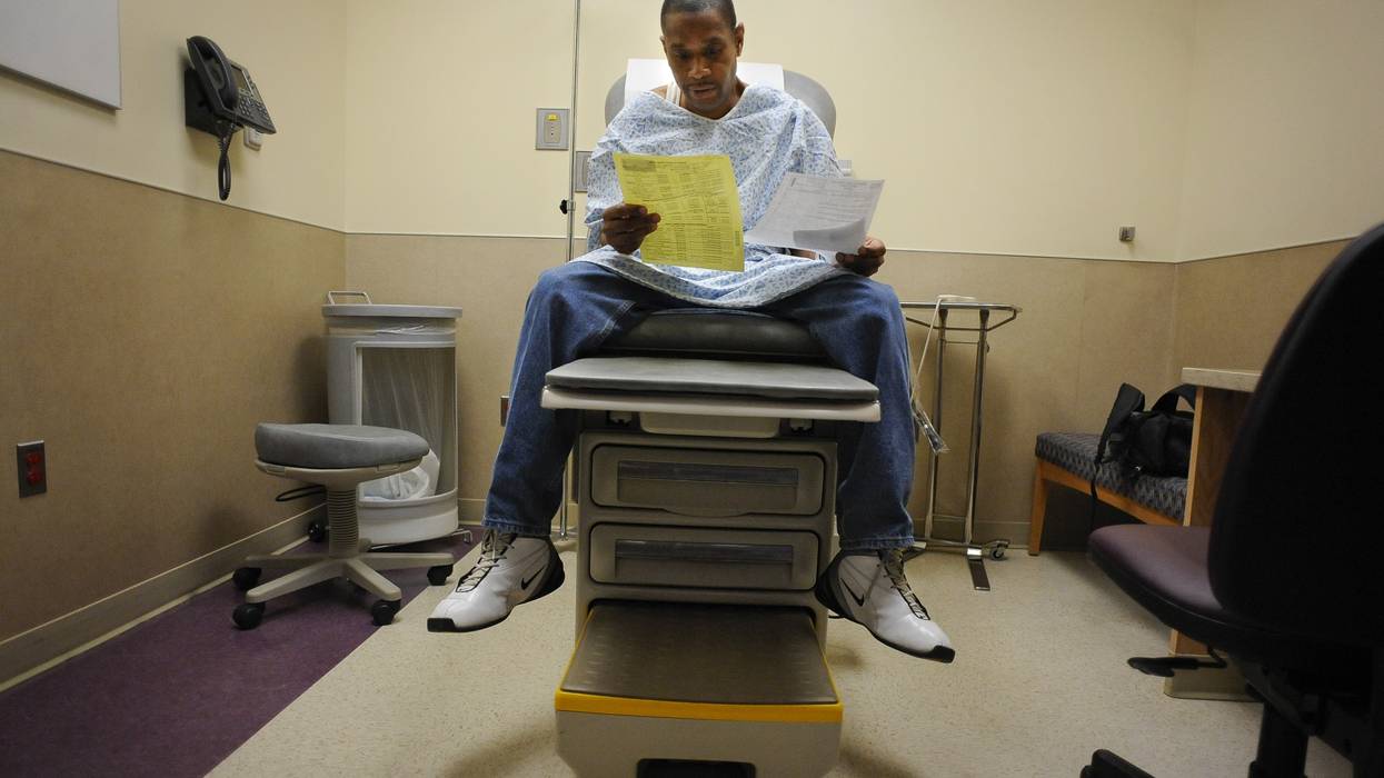 A Medicaid patient looks at paperwork.