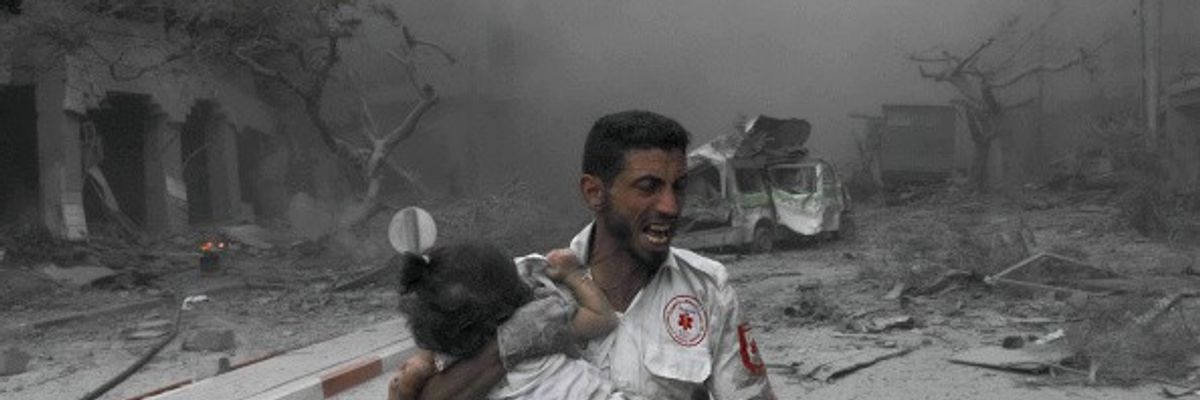 A medical worker rushes a child to the ambulance for treatment
