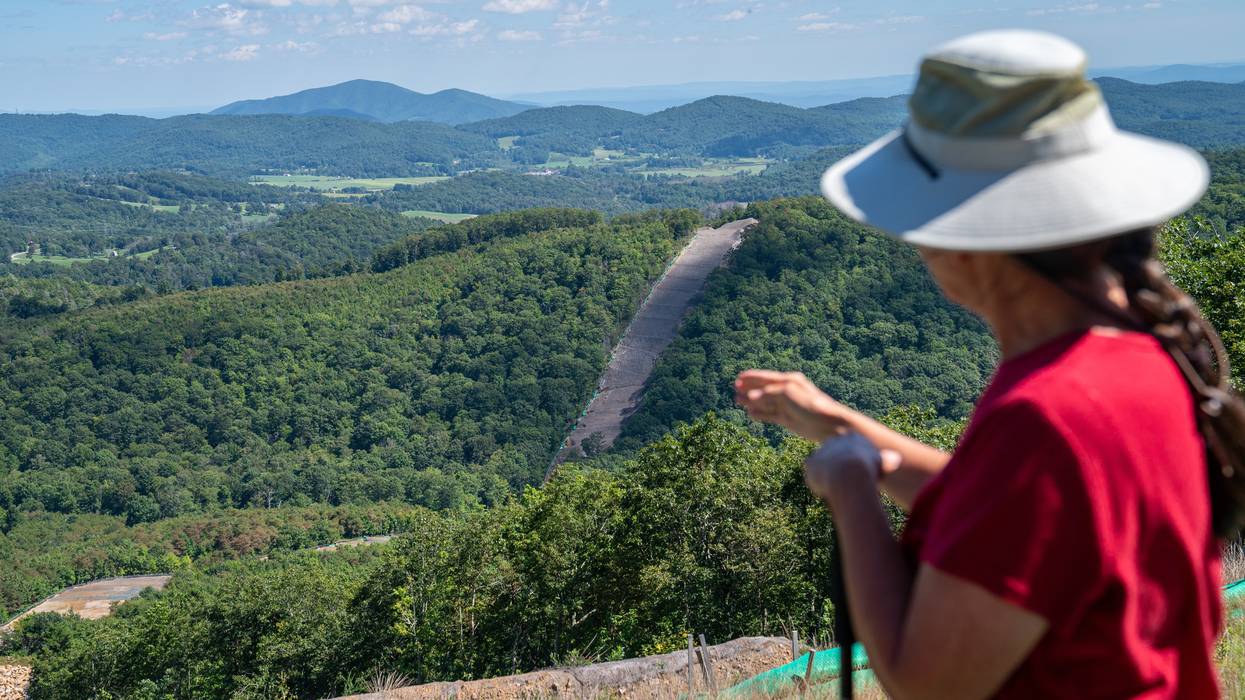 A member of Protect Our Water, Heritage, Rights (POWHR) views where sections of steel pipe of the Mountain Valley Pipeline have been buried