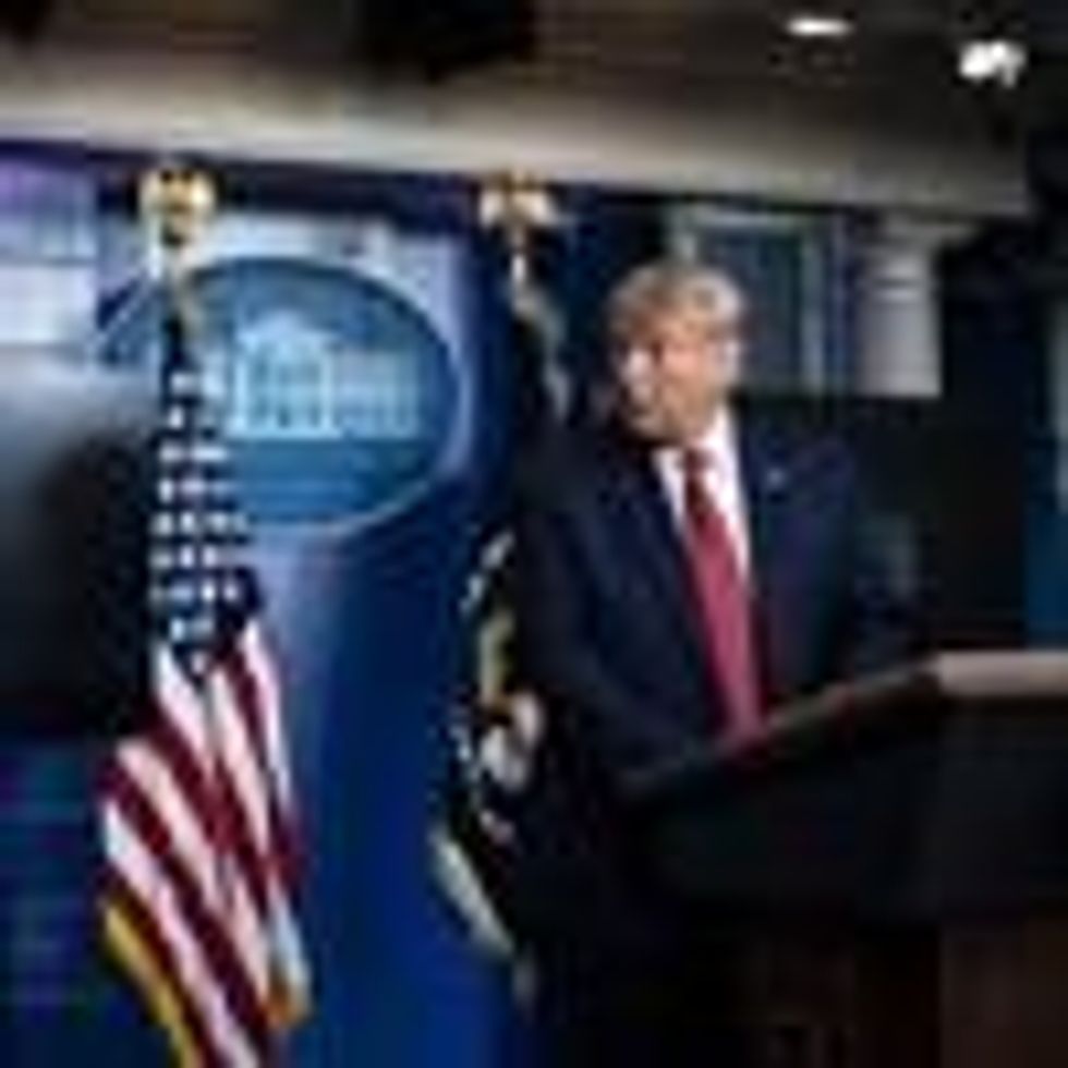A member of the Secret Service speaks to then-President Donald Trump at the White House on August 10, 2020 in Washington, D.C.