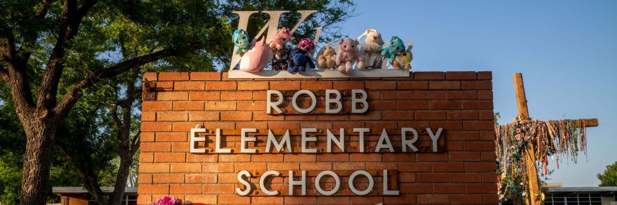 A memorial around the sign for Robb Elementary School.
