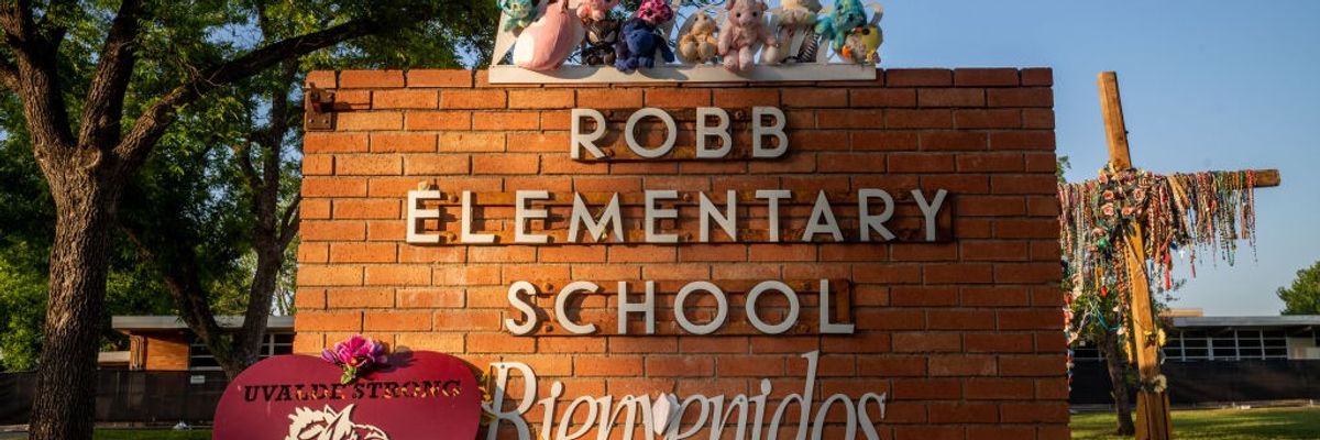 A memorial around the sign for Robb Elementary School.