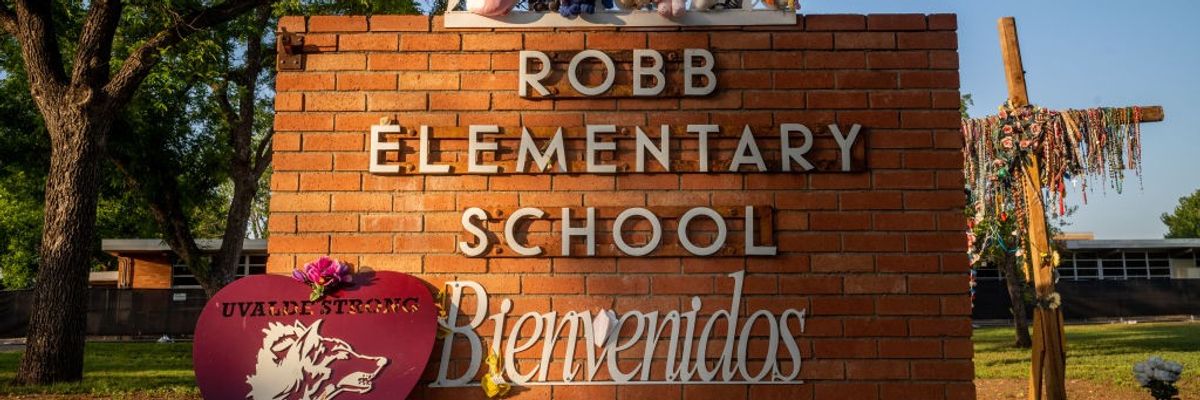 A memorial around the sign for Robb Elementary School.