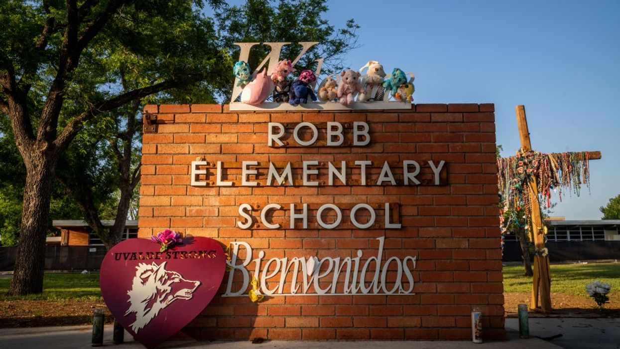 A memorial around the sign for Robb Elementary School.
