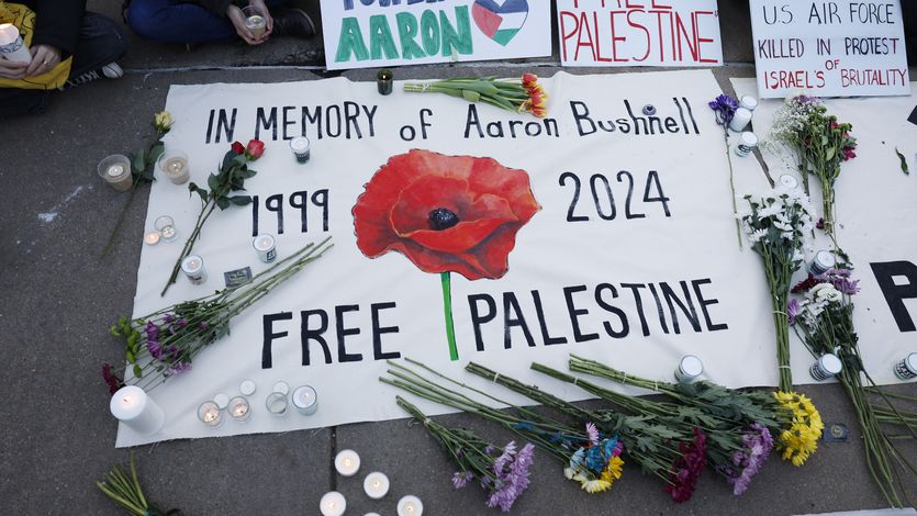 A memorial for Aaron Bushnell with flowers.