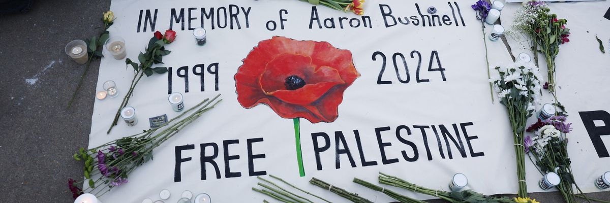 A memorial for Aaron Bushnell with flowers.