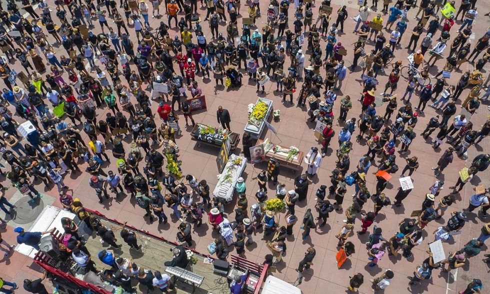 A memorial service in downtown Los Angeles on June 8, 2020, for George Floyd and other victims of police killings. Protesters held numerous processions and memorial services to commemorate Floyd on the day before his funeral in his hometown of Houston. (Photo: David McNew/Getty Images)