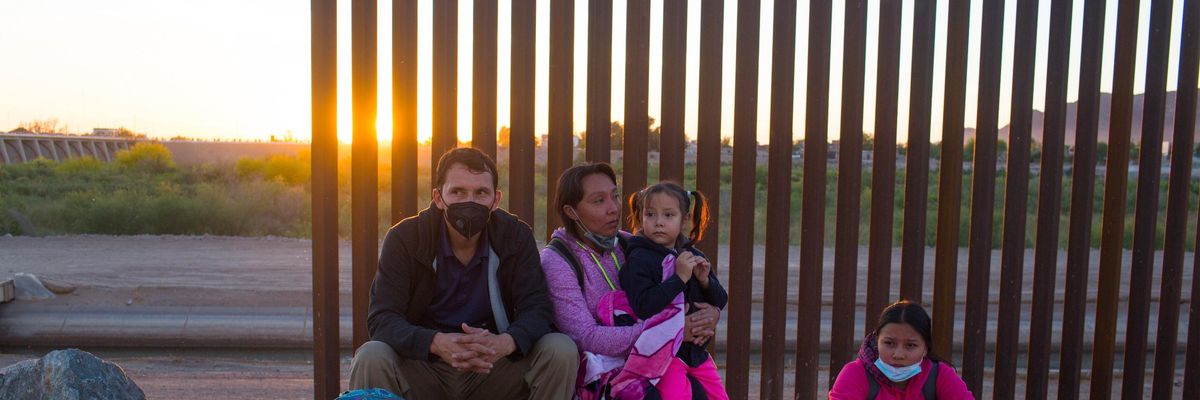 A migrant family from Central America waits to be processed by the U.S. Border Patrol after they crossed into the United States from Mexico on April 29, 2021 near Yuma, Arizona. (Photo: Andrew Lichtenstein/Corbis via Getty Images)