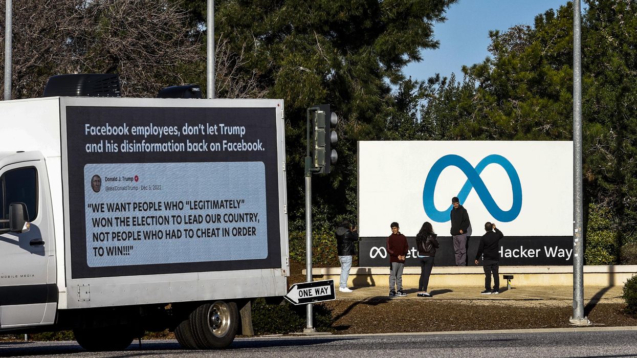 A mobile billboard outside Meta headquarters that reads "Facebook employees, don't let Trump and his disinformation back on Facebook."