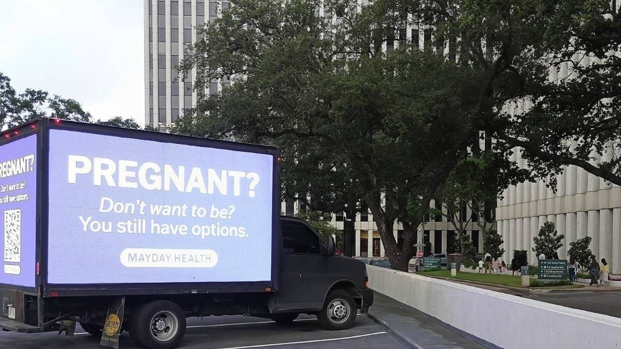 A mobile billboard reads, "Pregnant? Don't want to be? You still have options."
