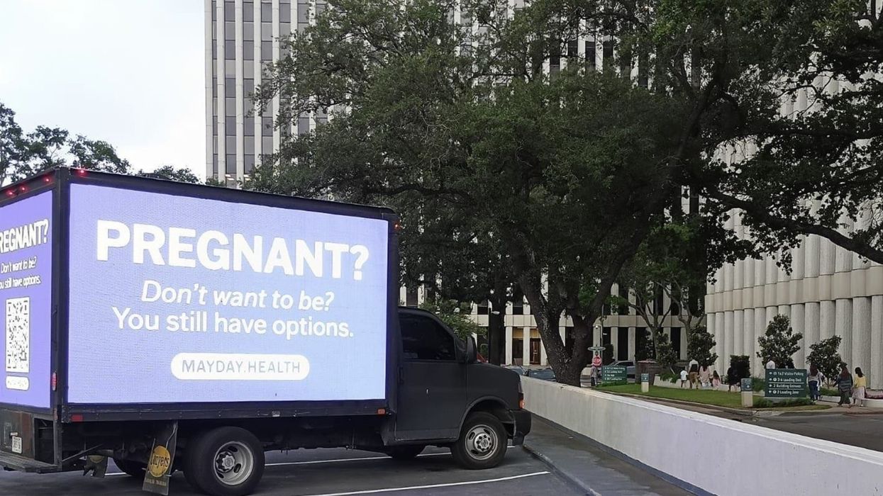 A mobile billboard reads, "Pregnant? Don't want to be? You still have options."