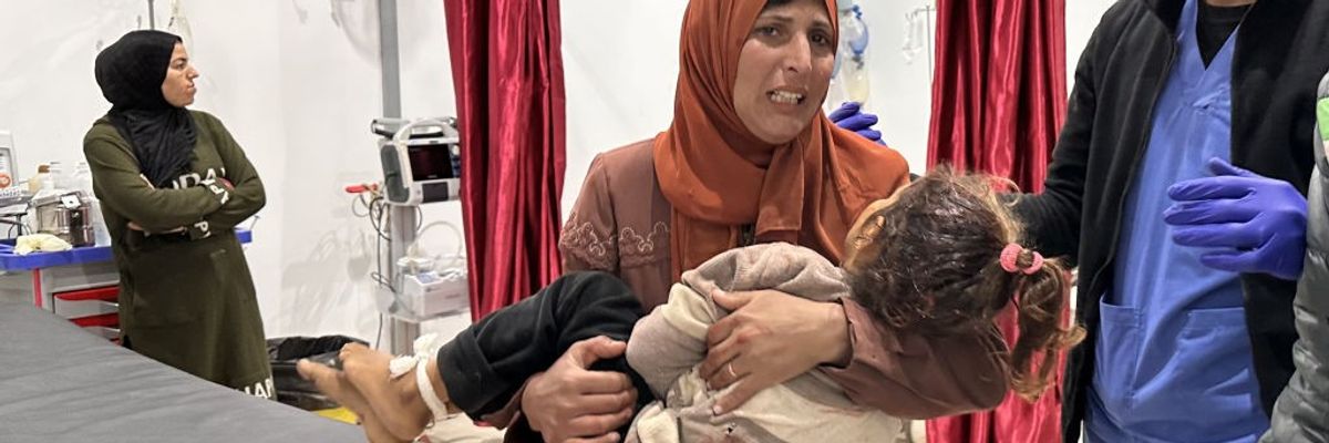 A mother carries the body of her daughter, who was killed by IDF shelling in Gaza after the cease-fire