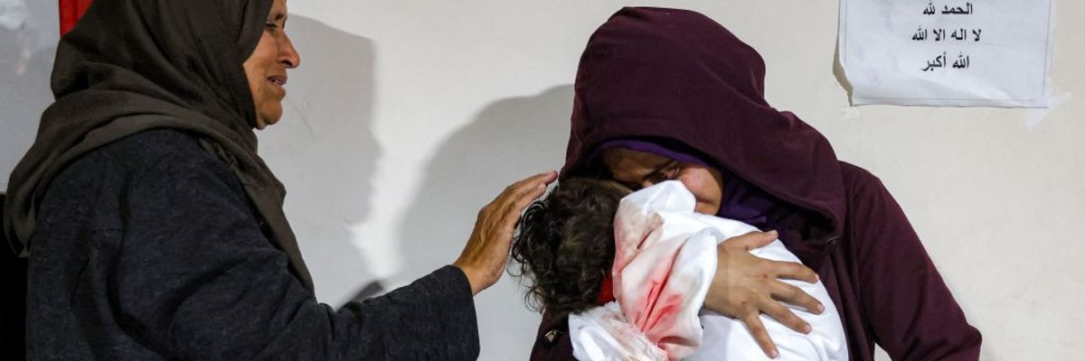 A mother cradles the body of her daughter in Gaza