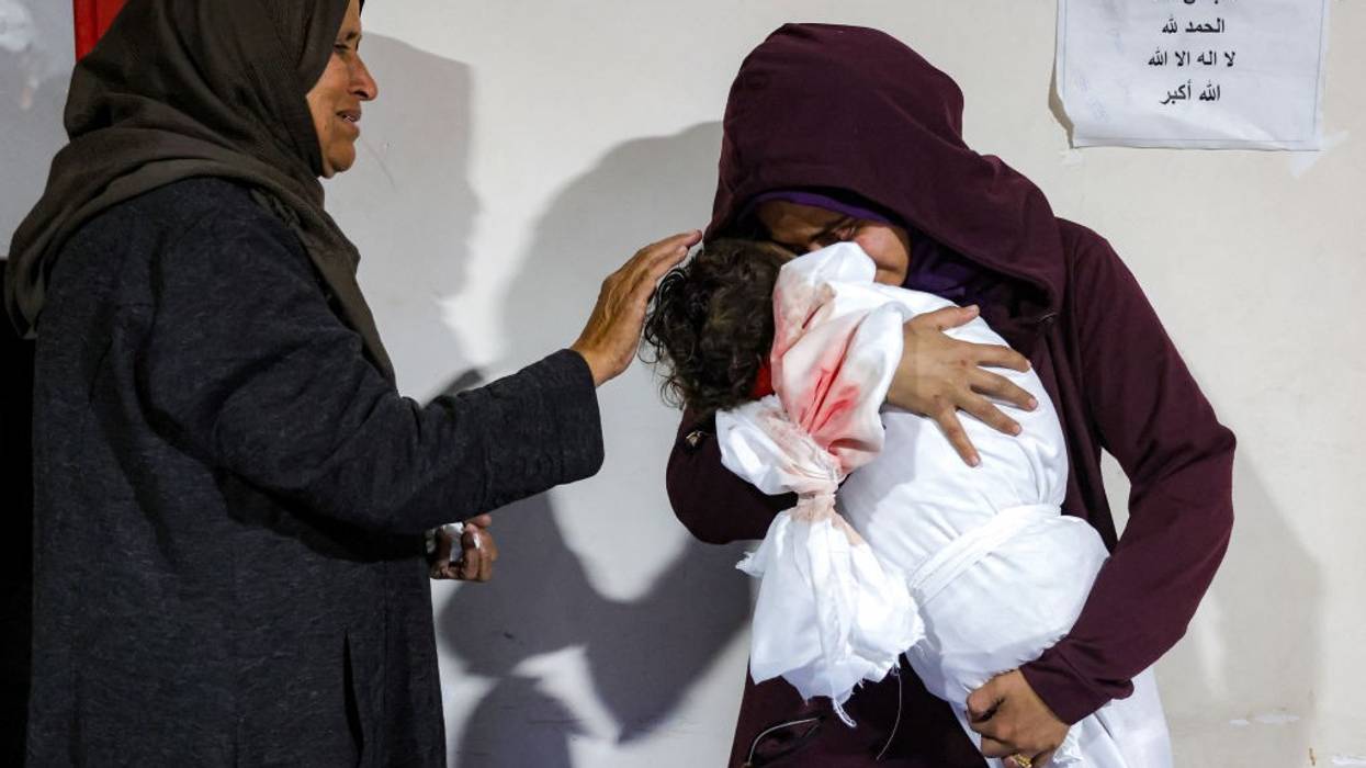 A mother cradles the body of her daughter in Gaza