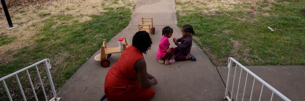 A mother watches her twin children