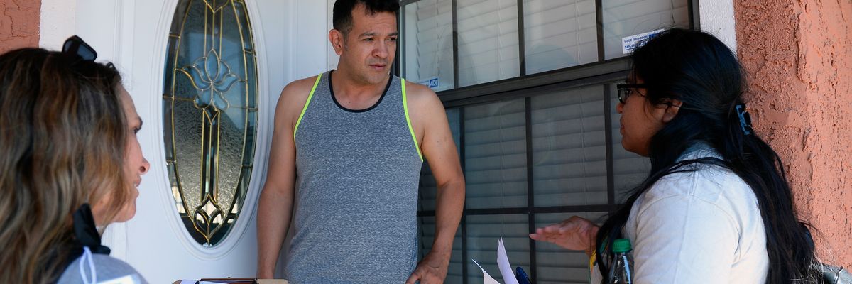 A Nevada resident speaks with canvassers in Las Vegas