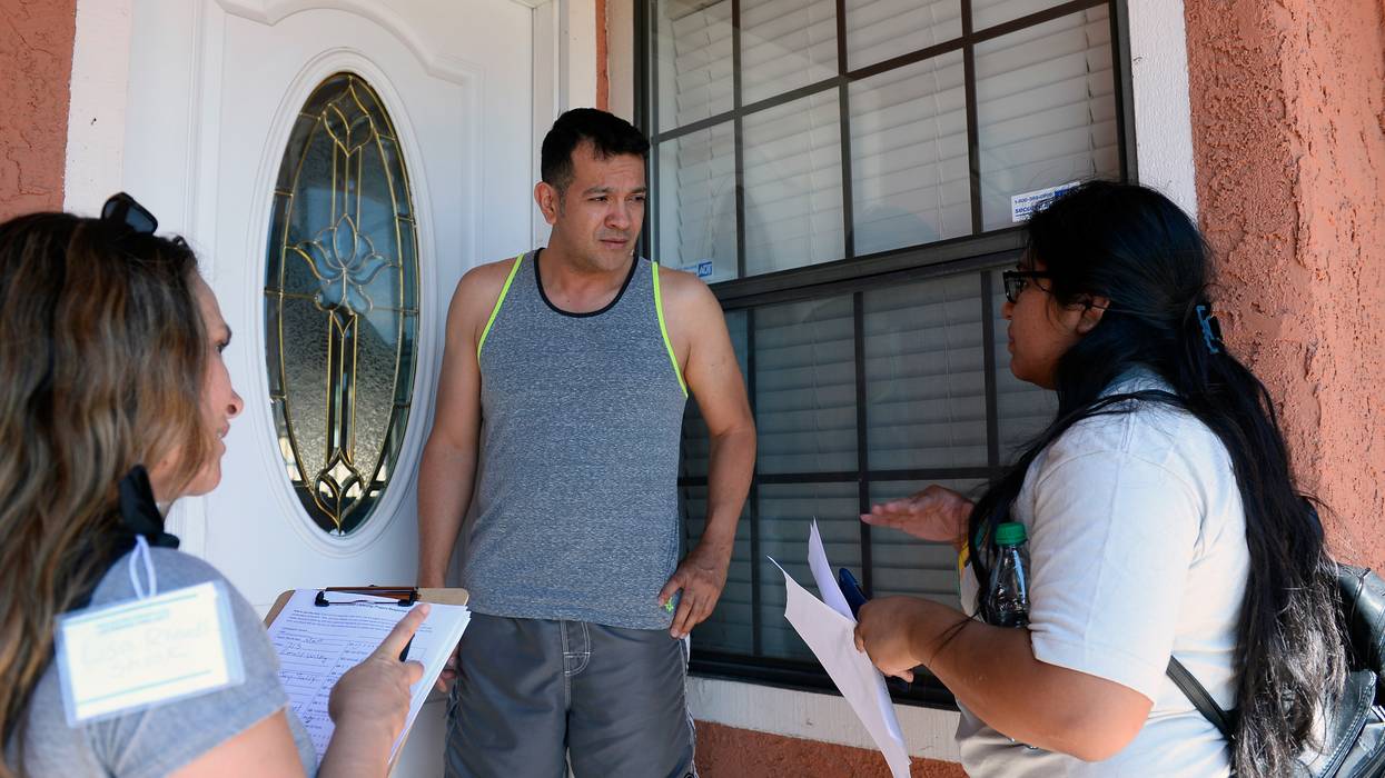 A Nevada resident speaks with canvassers in Las Vegas