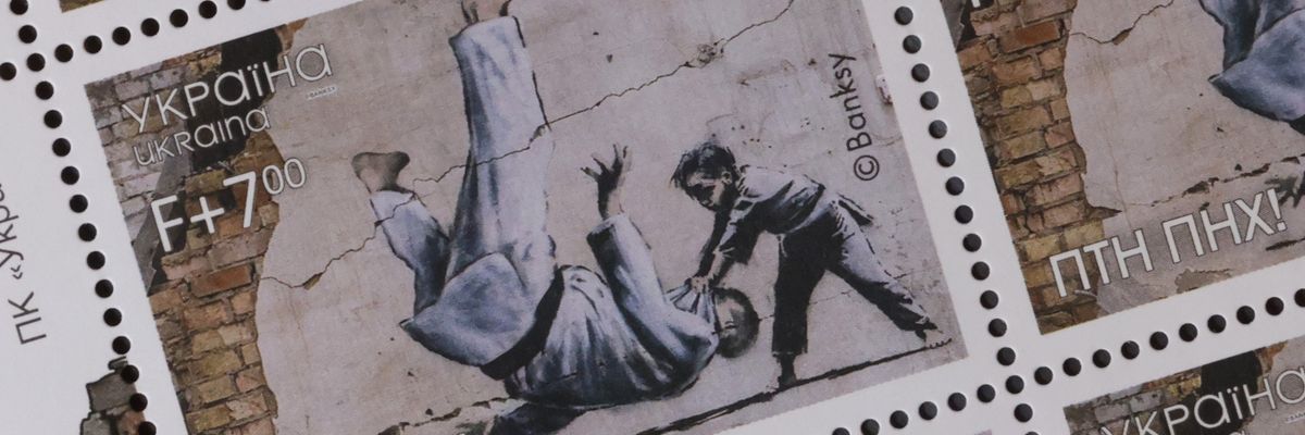 A new Ukrainian stamp shows a Banksy image of a young boy slamming Putin to the ground in a judo match