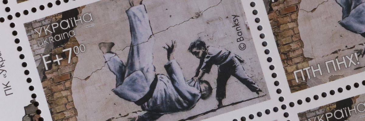 A new Ukrainian stamp shows a Banksy image of a young boy slamming Putin to the ground in a judo match