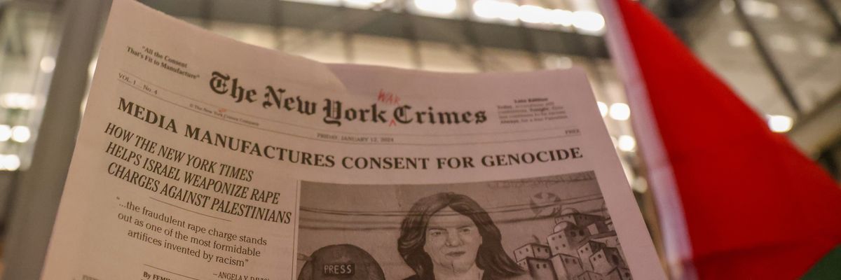 A New York Times satire paper titled New York Crimes is raised in a demonstration.