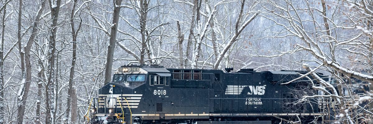 A Norfolk Southern locomotive travels along the Susquehanna River during light snowfall in Danville, Pennsylvania on February 22, 2021.