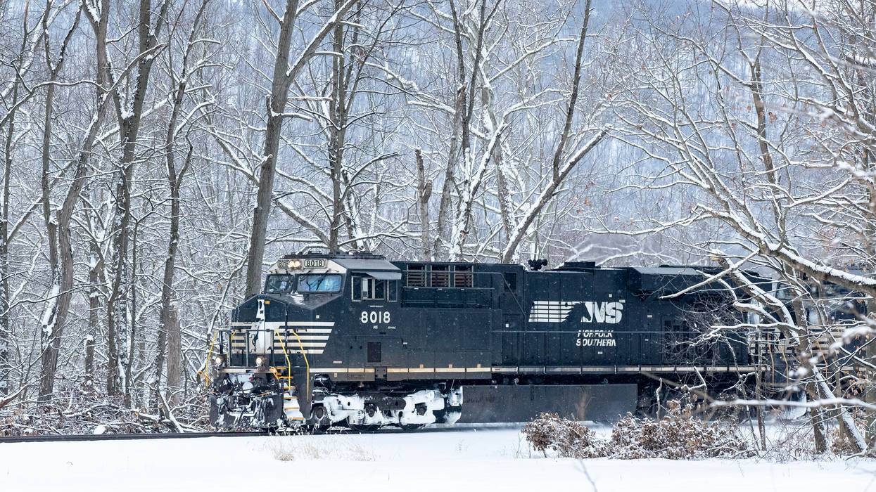 A Norfolk Southern locomotive travels along the Susquehanna River during light snowfall in Danville, Pennsylvania on February 22, 2021.