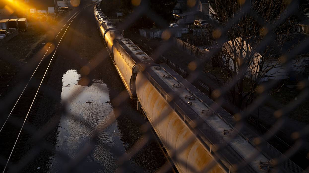A Norfolk Southern train passes underneath a bridge on February 25, 2023 in East Palestine, Ohio.