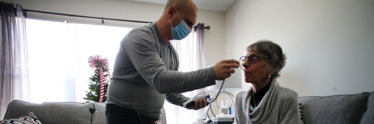 A nurse cares for a patient at home
