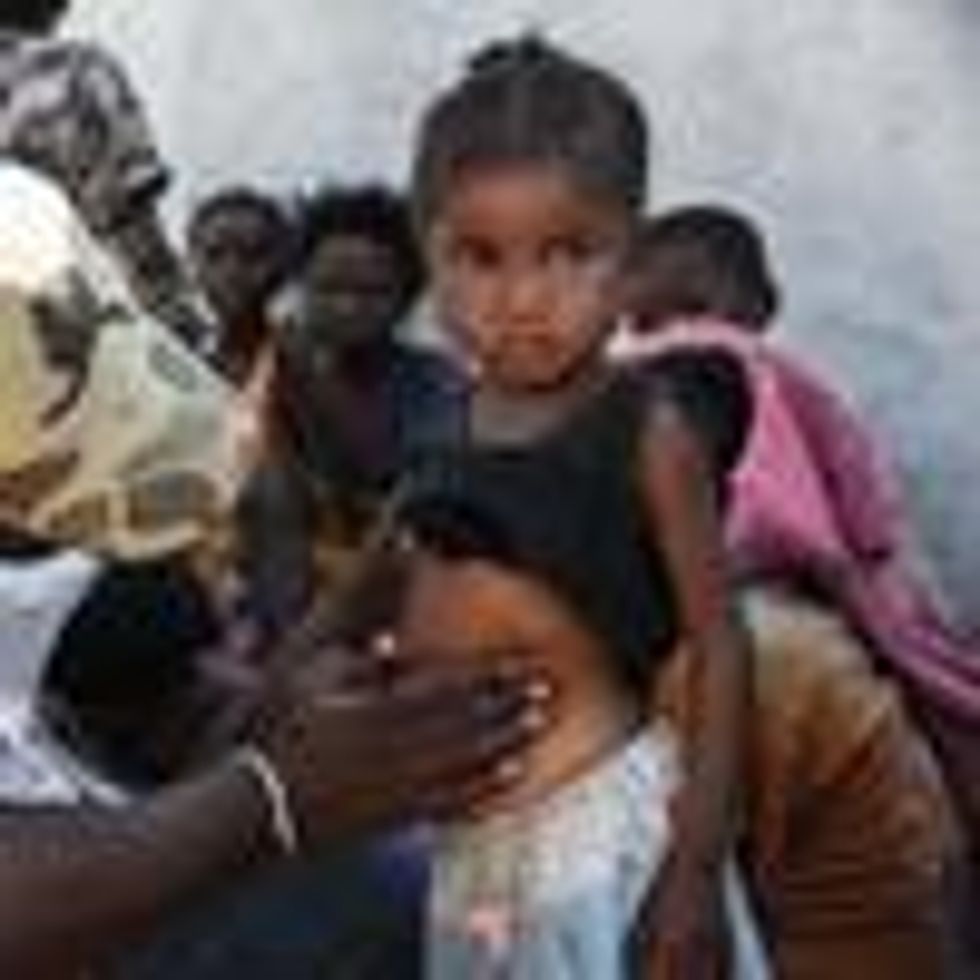 A nurse from a Doctors Without Borders mobile clinic set up to treat the most serious cases of malnutrition in southern Madagascar inspects a child in the village of Befeno on September 2, 2021.