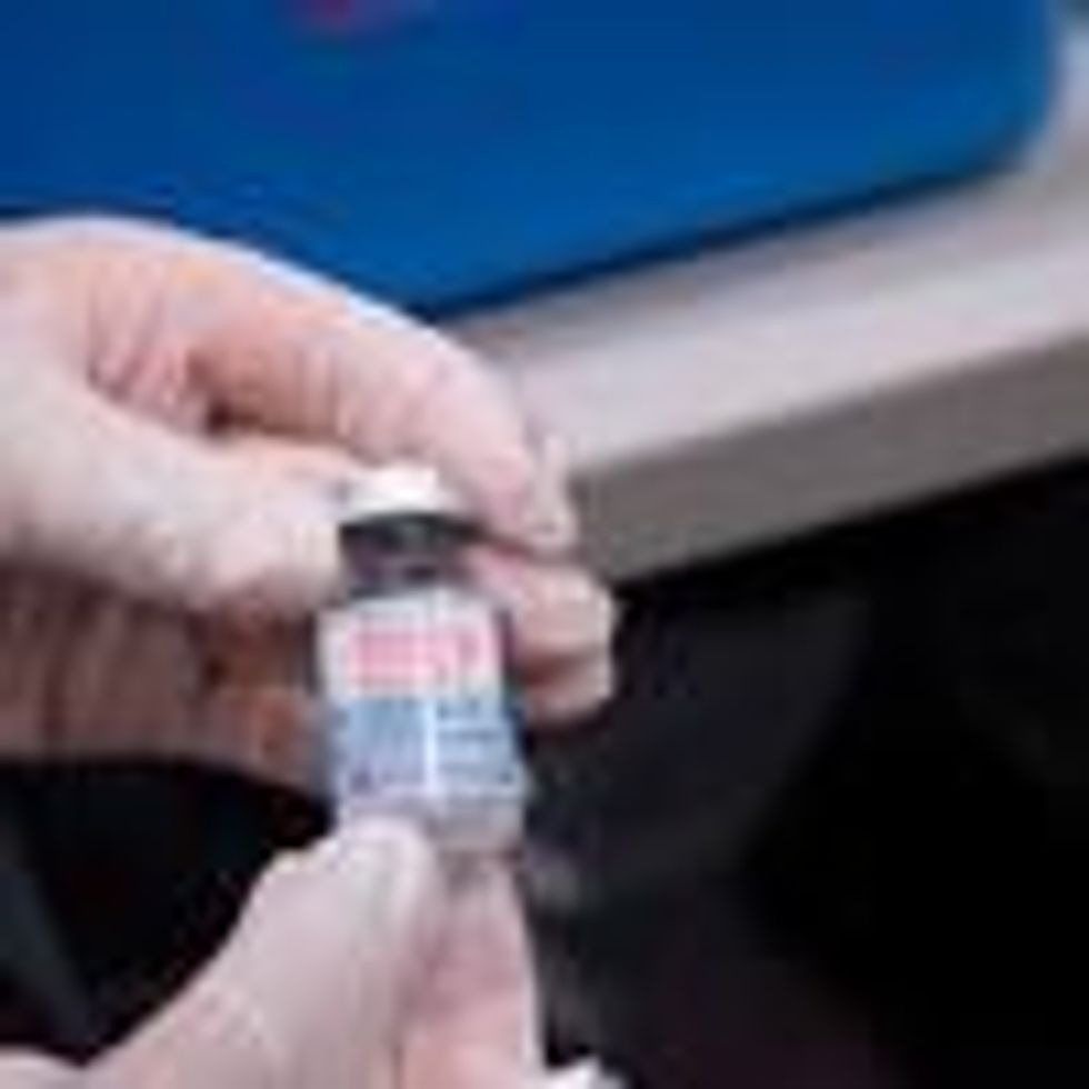 A nurse holds a vial of the Moderna vaccine
