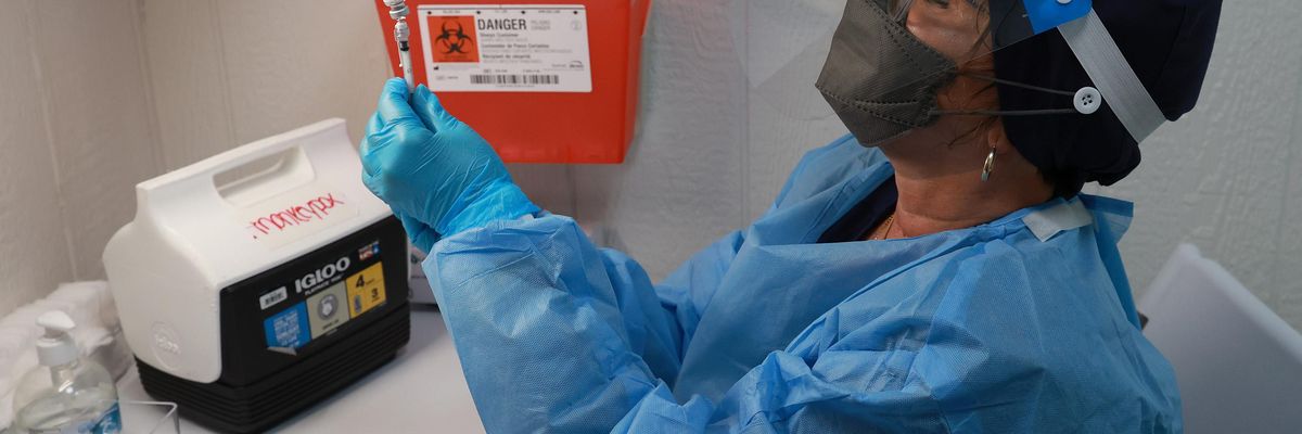 A nurse measures a monkeypox vaccine