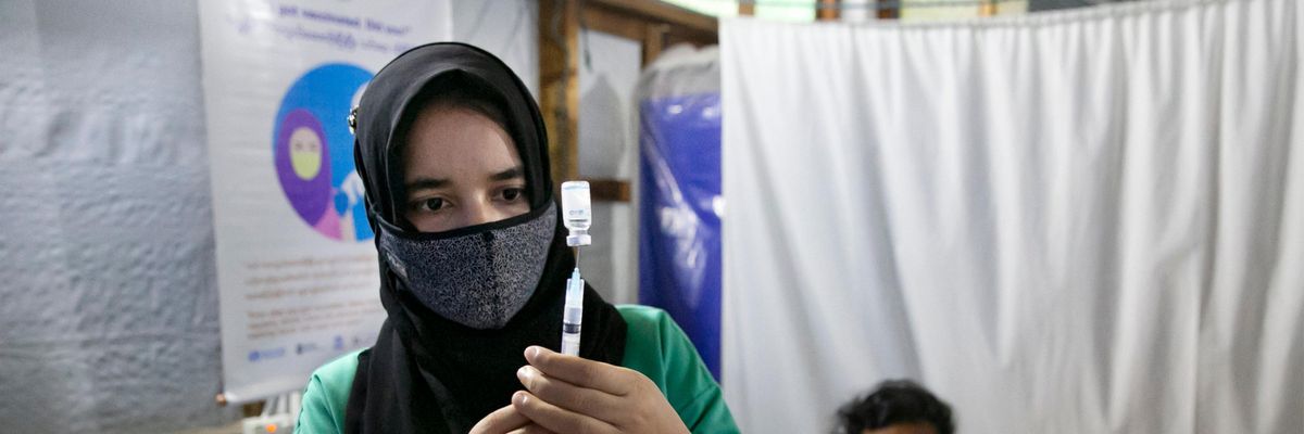 A nurse prepares a coronavirus vaccine dose for a patient