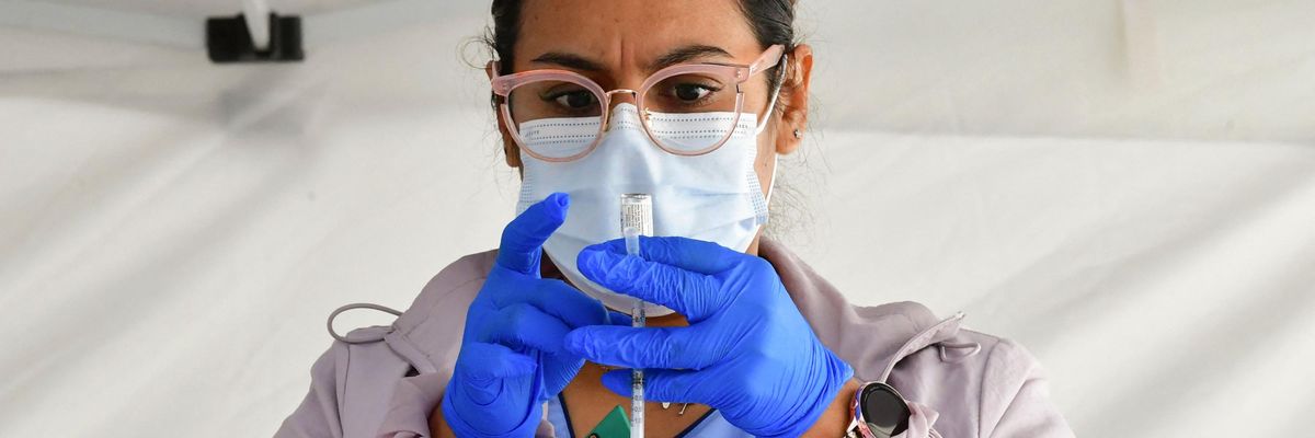 A nurse prepares a coronavirus vaccine dose.