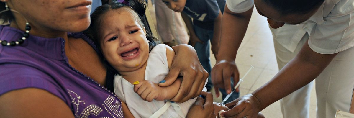 A nurse vaccinates a child against pneumonia