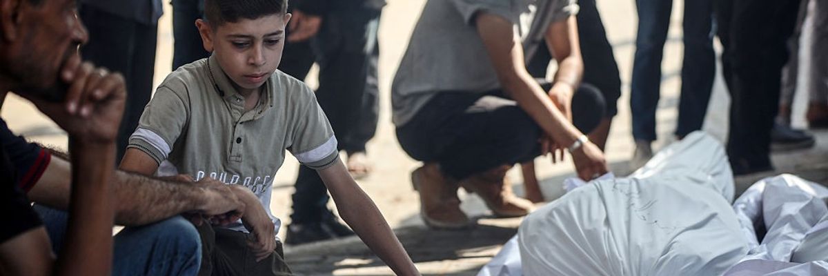 A Palestinian boy mourns people killed in an aid massacre