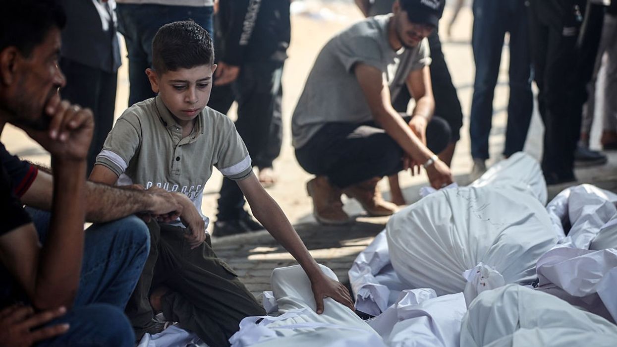 A Palestinian boy mourns people killed in an aid massacre