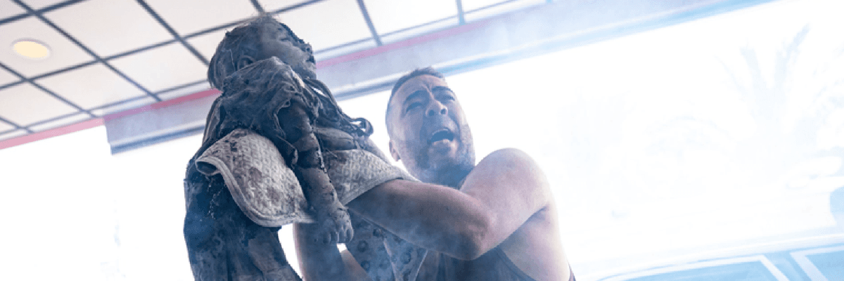 A Palestinian man arrives at a hospital holding the body of a girl