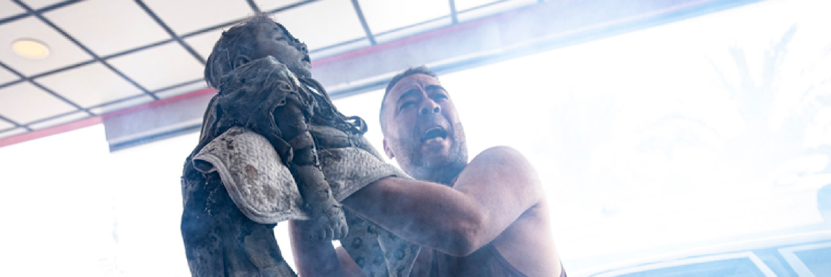 A Palestinian man arrives at a hospital holding the body of a girl