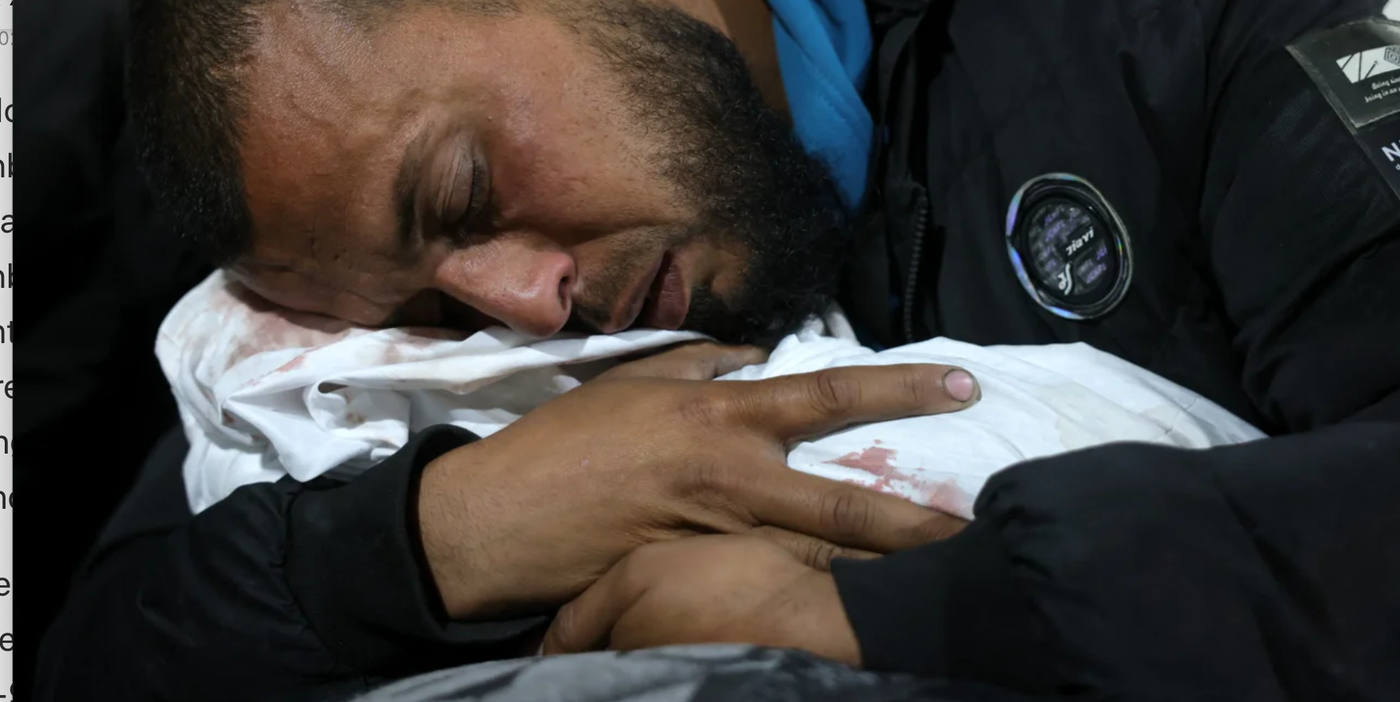A Palestinian man hugs the body of his baby at Indonesian Hospital
