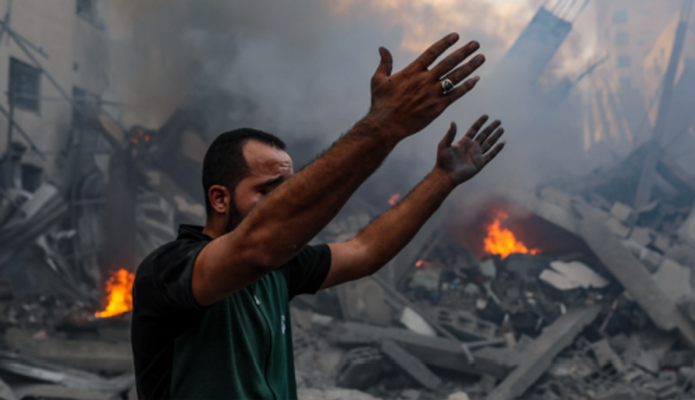 A Palestinian man weeps in the rubble of Gaza City after Israeli airstrikes.