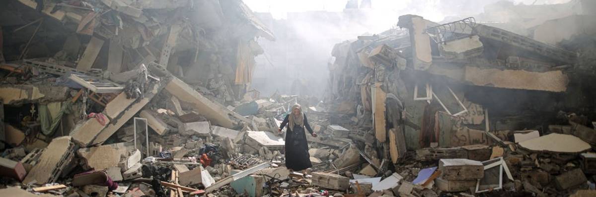A Palestinian resident walks amid near the rubble of buildings after Israeli bombings in Gaza