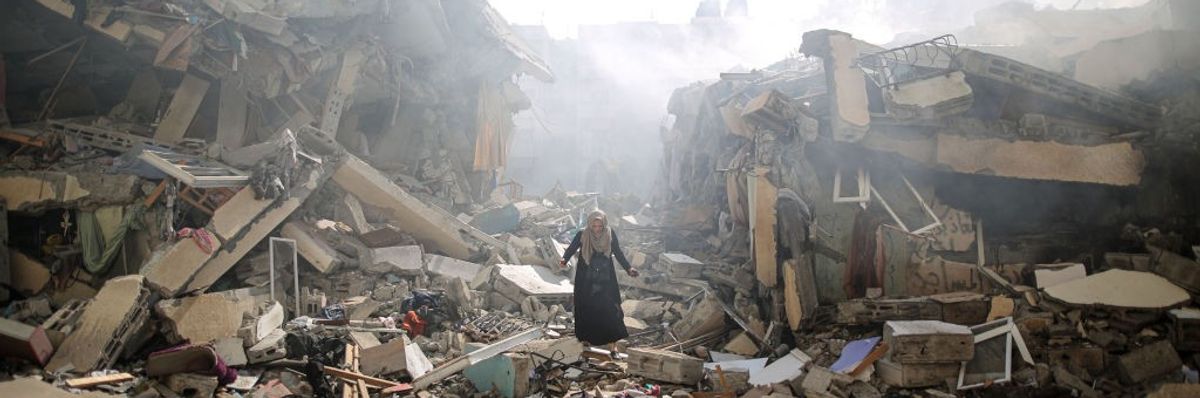 A Palestinian resident walks amid near the rubble of buildings after Israeli bombings in Gaza