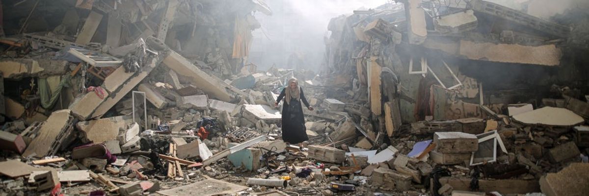 A Palestinian resident walks amid near the rubble of buildings after Israeli bombings in Gaza