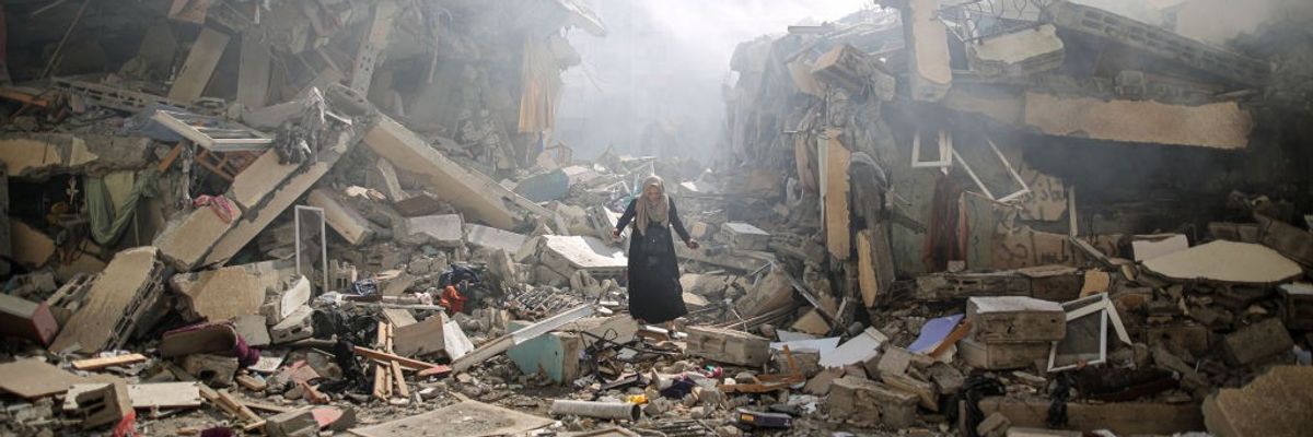 A Palestinian resident walks amid near the rubble of buildings after Israeli bombings in Gaza